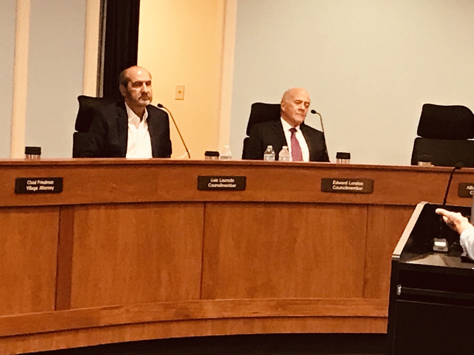 Councilmembers Lauredo and London listen during public comments